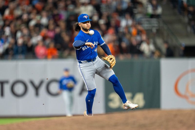 Jul 9, 2024; San Francisco, California, USA;  Toronto Blue Jays shortstop Bo Bichette (11) throws out San Francisco Giants first baseman Wilmer Flores (41) during the ninth inning at Oracle Park. Mandatory Credit: Neville E. Guard-USA TODAY Sports