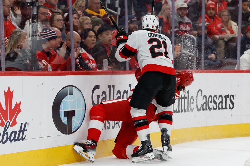 Jan 18, 2026; Detroit, Michigan, USA; Ottawa Senators center Nick Cousins (21) checks Detroit Red Wings defenseman Moritz Seider (53) in the first period at Little Caesars Arena. Mandatory Credit: Rick Osentoski-Imagn Images