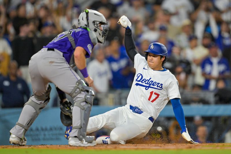 Sep 10, 2025; Los Angeles, California, USA; Los Angeles Dodgers designated hitter Shohei Ohtani (17) slides to score a run on a double by shortstop Mookie Betts (not pictured) in the second inning against the Colorado Rockies at Dodger Stadium. Mandatory Credit: Jayne Kamin-Oncea-Imagn Images