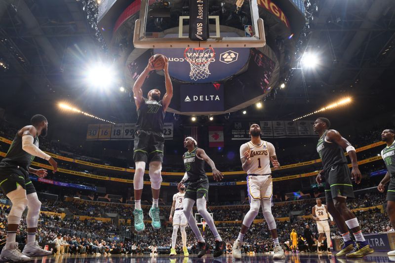 LOS ANGELES, CA - APRIL 7: Rudy Gobert #27 of the Minnesota Timberwolves rebounds the ball during the game against the Los Angeles Lakers on April 7, 2024 at Crypto.Com Arena in Los Angeles, California. NOTE TO USER: User expressly acknowledges and agrees that, by downloading and/or using this Photograph, user is consenting to the terms and conditions of the Getty Images License Agreement. Mandatory Copyright Notice: Copyright 2024 NBAE (Photo by Juan Ocampo/NBAE via Getty Images)