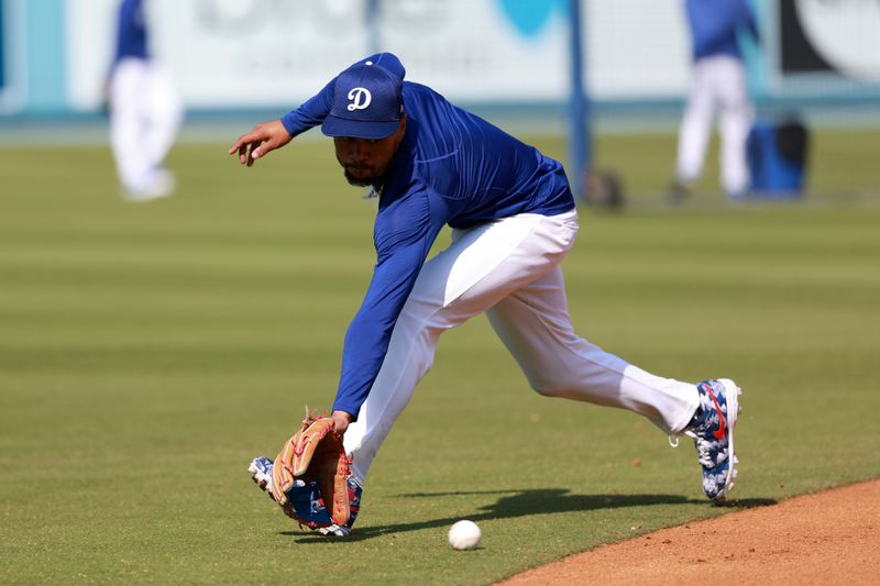 Apr 19, 2024; Los Angeles, California, USA;  Los Angeles Dodgers shortstop Mookie Betts (50) takes a ground ball prior to the game against the New York Mets at Dodger Stadium. Mandatory Credit: Kiyoshi Mio-USA TODAY Sports