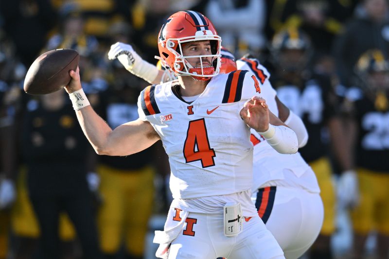 Nov 18, 2023; Iowa City, Iowa, USA; Illinois Fighting Illini quarterback John Paddock (4) throws a pass against the Iowa Hawkeyes during the first quarter at Kinnick Stadium. Mandatory Credit: Jeffrey Becker-USA TODAY Sports