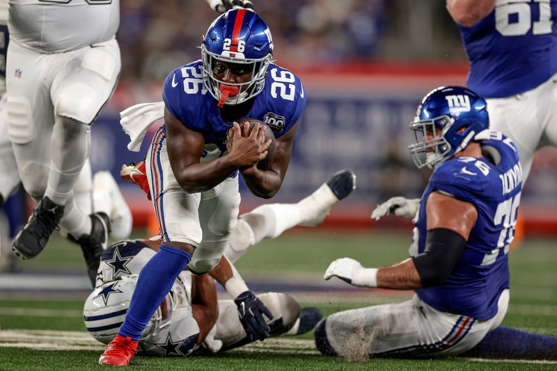 New York Giants running back Devin Singletary (26) carries the ball against the Dallas Cowboys during the second quarter of an NFL football game, Thursday, Sept. 26, 2024, in East Rutherford, N.J. (AP Photo/Adam Hunger)