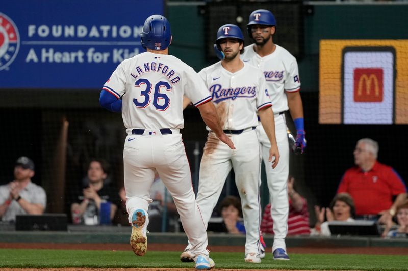 Apr 24, 2024; Arlington, Texas, USA; Texas Rangers designated hitter Wyatt Langford (36) and third baseman Josh Smith (8) celebrate after scoring against the Seattle Mariners during the sixth inning at Globe Life Field. Mandatory Credit: Jim Cowsert-USA TODAY Sports