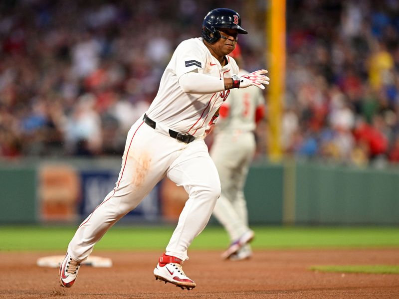 Jun 12, 2024; Boston, Massachusetts, USA; Boston Red Sox third base Rafael Devers (11) runs for third base after hitting a triple against the Philadelphia Phillies during the fourth inning at Fenway Park. Mandatory Credit: Brian Fluharty-USA TODAY Sports