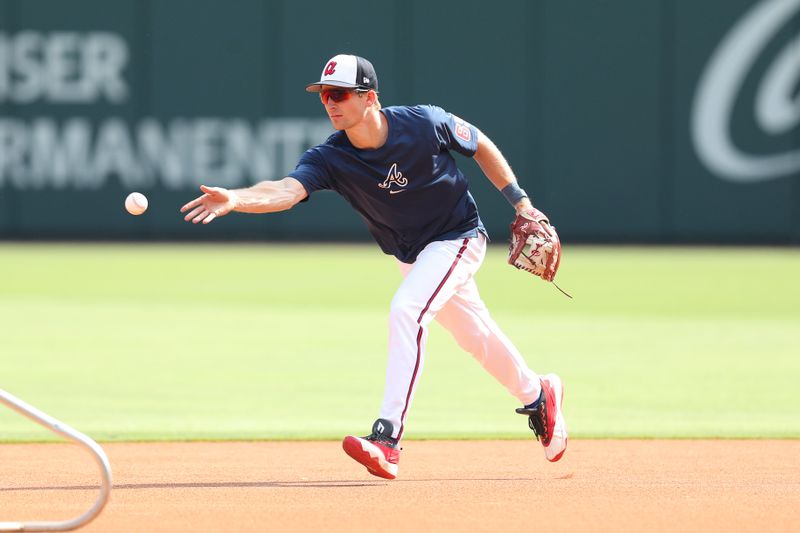 Apr 20, 2024; Cumberland, Georgia, USA; Atlanta Braves shortstop Luke Williams (65) tosses the ball before a game against the Texas Rangers at Truist Park. Mandatory Credit: Mady Mertens-USA TODAY Sports