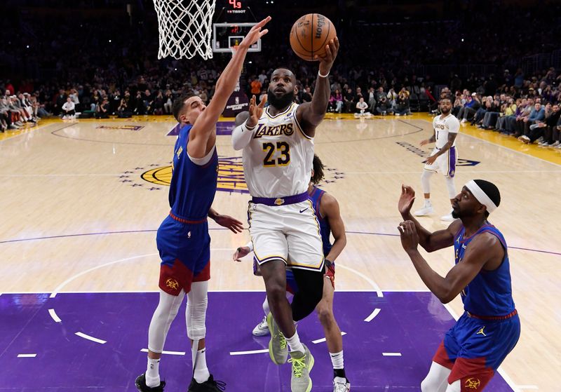 LOS ANGELES, CALIFORNIA - MARCH 02: LeBron James #23 of the Los Angeles Lakers scores his 40,000th career point during the first half against Michael Porter Jr. #1 of the Denver Nuggets at Crypto.com Arena on March 2, 2024 in Los Angeles, California. NOTE TO USER: User expressly acknowledges and agrees that, by downloading and or using this photograph, User is consenting to the terms and conditions of the Getty Images License Agreement.(Photo by Kevork Djansezian/Getty Images)