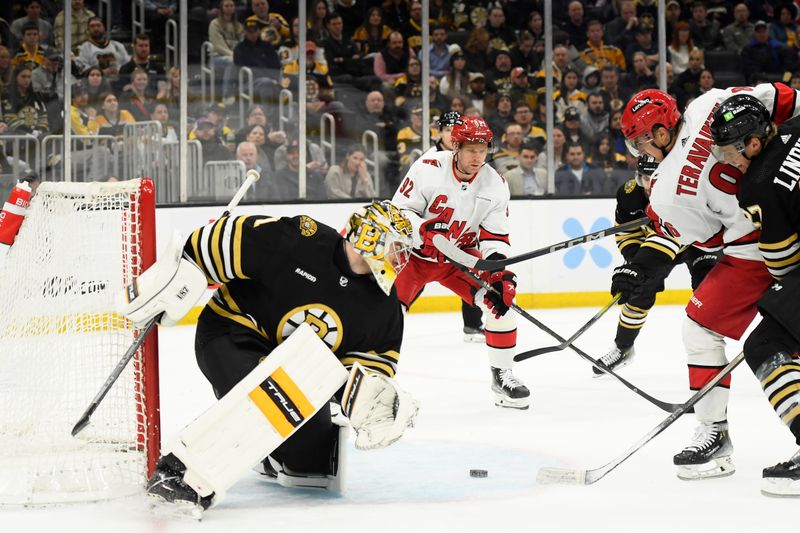 Apr 9, 2024; Boston, Massachusetts, USA; Carolina Hurricanes left wing Teuvo Teravainen (86) looks for a loose puck in front of Boston Bruins goaltender Jeremy Swayman (1) during the second period at TD Garden. Mandatory Credit: Bob DeChiara-USA TODAY Sports