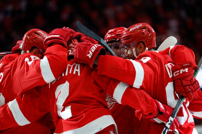 Feb 29, 2024; Detroit, Michigan, USA;  Detroit Red Wings defenseman Olli Maatta (2) receives congratulations from teammates after scoring in the second period against the New York Islanders at Little Caesars Arena. Mandatory Credit: Rick Osentoski-USA TODAY Sports