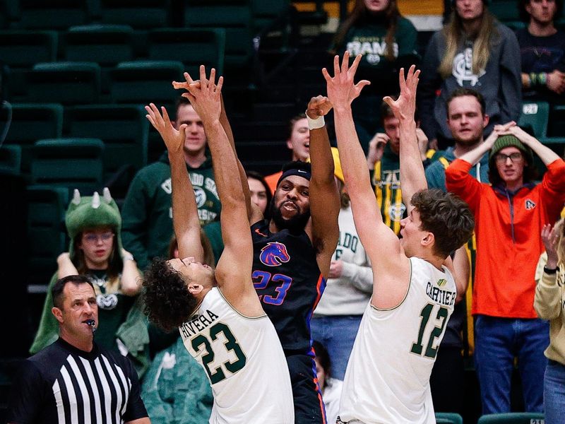 Feb 15, 2023; Fort Collins, Colorado, USA; Boise State Broncos forward Naje Smith (23) passes the ball as Colorado State Rams guard Isaiah Rivera (23) and forward Patrick Cartier (12) defend in the second half at Moby Arena. Mandatory Credit: Isaiah J. Downing-USA TODAY Sports