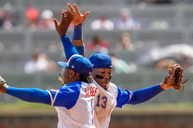 Jul 30, 2023; Cumberland, Georgia, USA; Atlanta Braves second baseman Ozzie Albies (1) and right fielder Ronald Acuna Jr. (13) react after the Braves defeated the Milwaukee Brewers at Truist Park. Mandatory Credit: Dale Zanine-USA TODAY Sports