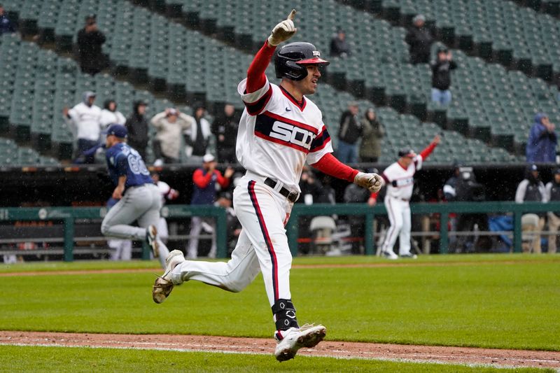 Apr 30, 2023; Chicago, Illinois, USA; Chicago White Sox center fielder Adam Haseley (51) hits a one-run RBI single against the Tampa Bay Raysduring the ninth inning at Guaranteed Rate Field. Mandatory Credit: David Banks-USA TODAY Sports