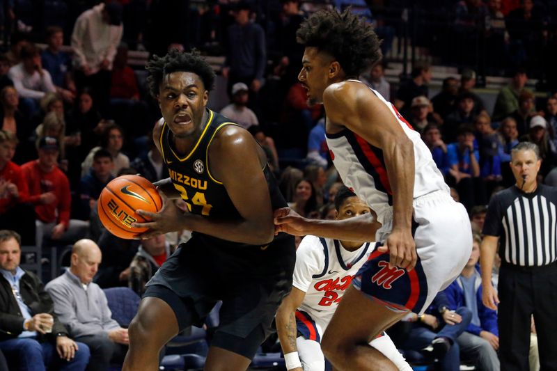 Jan 24, 2023; Oxford, Mississippi, USA; Missouri Tigers guard/forward Kobe Brown (24) drives to the basket as Mississippi Rebels forward Jaemyn Brakefield (4) defends during the first half at The Sandy and John Black Pavilion at Ole Miss. Mandatory Credit: Petre Thomas-USA TODAY Sports