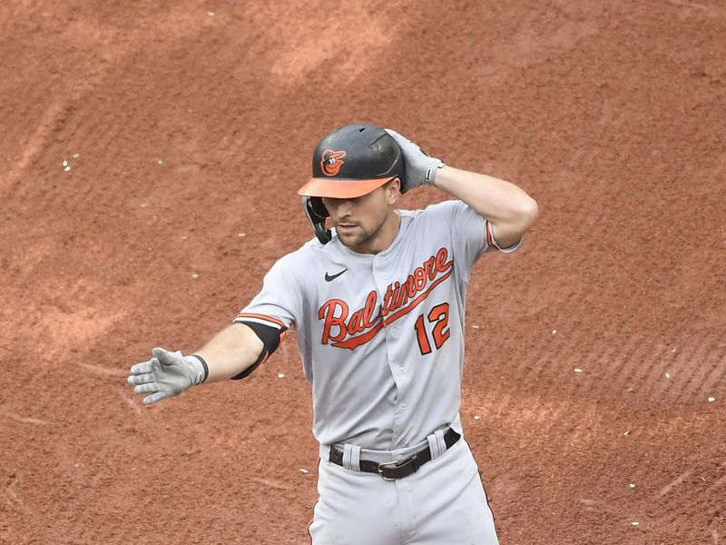 Sep 10, 2023; Boston, Massachusetts, USA;  Baltimore Orioles second baseman Adam Frazier (12) reacts after reaching third base on an error by the Boston Red Sox during the second inning at Fenway Park. Mandatory Credit: Bob DeChiara-USA TODAY Sports