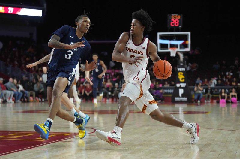 Feb 11, 2025; Los Angeles, California, USA; Southern California Trojans guard Wesley Yates III (6) dribbles the ball against Penn State Nittany Lions guard Nick Kern Jr. (3) in the second half at Galen Center. Mandatory Credit: Kirby Lee-Imagn Images