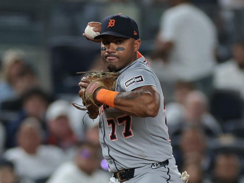 Sep 10, 2025; Bronx, New York, USA;  Detroit Tigers third baseman Andy Ibanez (77) throws the ball to first base for an out during the third inning against the New York Yankees at Yankee Stadium. Mandatory Credit: Vincent Carchietta-Imagn Images