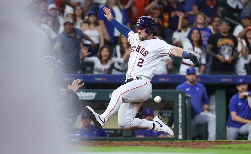 May 17, 2023; Houston, Texas, USA; Houston Astros third baseman Alex Bregman (2) slides ahead of the throw to score the winning run during the ninth inning against the Chicago Cubs at Minute Maid Park. Mandatory Credit: Troy Taormina-USA TODAY Sports