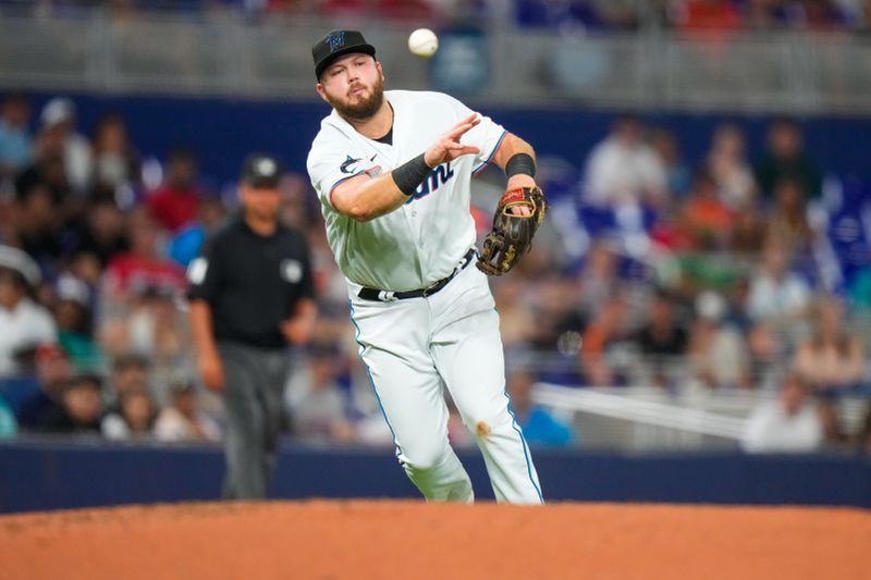 Aug 14, 2023; Miami, Florida, USA; Miami Marlins third baseman Jake Burger (36) throws the ball to first base for an out against the Houston Astros during the fourth inning at loanDepot Park. Mandatory Credit: Rich Storry-USA TODAY Sports