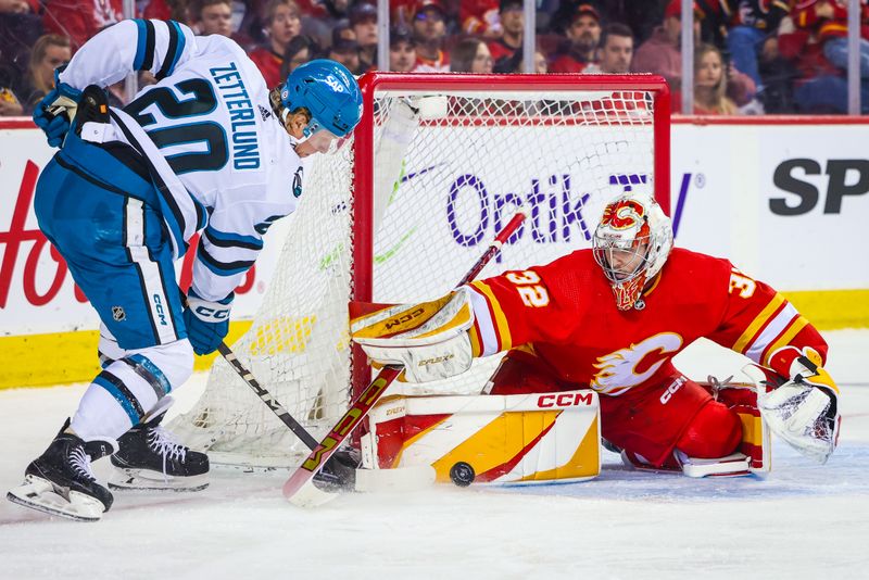 Apr 18, 2024; Calgary, Alberta, CAN; Calgary Flames goaltender Dustin Wolf (32) makes a save against San Jose Sharks left wing Fabian Zetterlund (20) during the first period at Scotiabank Saddledome. Mandatory Credit: Sergei Belski-USA TODAY Sports