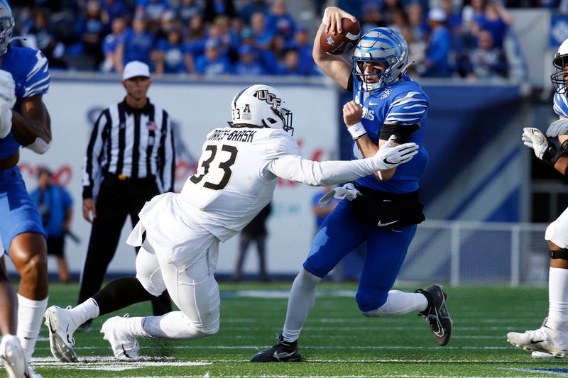 Nov 5, 2022; Memphis, Tennessee, USA; Memphis Tigers quarterback Seth Henigan (5) runs the ball as UCF Knights defensive end Tre'mon Morris-Brash (33) attempts to make the tackle during the first half at Liberty Bowl Memorial Stadium. Mandatory Credit: Petre Thomas-USA TODAY Sports