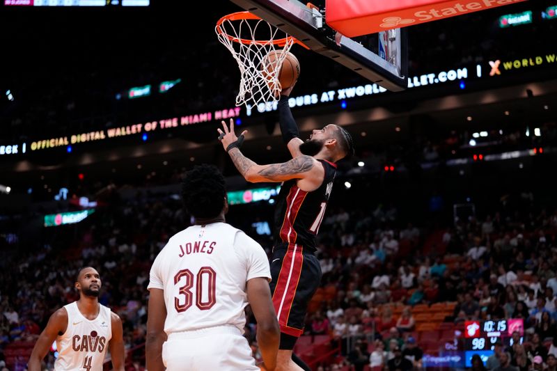 MIAMI, FLORIDA - MARCH 24: Caleb Martin #16 of the Miami Heat goes up for a shot against Damian Jones #30 of the Cleveland Cavaliers during the fourth quarter at Kaseya Center on March 24, 2024 in Miami, Florida. NOTE TO USER: User expressly acknowledges and agrees that, by downloading and or using this photograph, User is consenting to the terms and conditions of the Getty Images License Agreement. (Photo by Rich Storry/Getty Images)