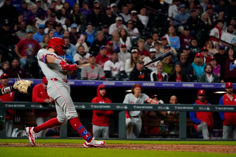 May 25, 2024; Denver, Colorado, USA;  Philadelphia Phillies first base Kody Clemens (2) breaks his bat on a ground-out double at Coors Field. Mandatory Credit: Michael Madrid-USA TODAY Sports