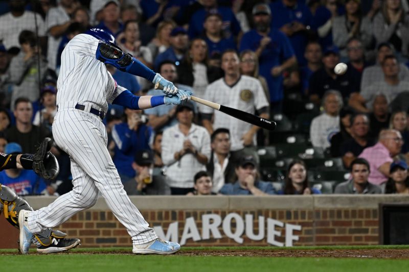 Sep 20, 2023; Chicago, Illinois, USA; Chicago Cubs left fielder Ian Happ (8) hits a grand slam against the Pittsburgh Pirates during the fifth inning at Wrigley Field. Mandatory Credit: Matt Marton-USA TODAY Sports