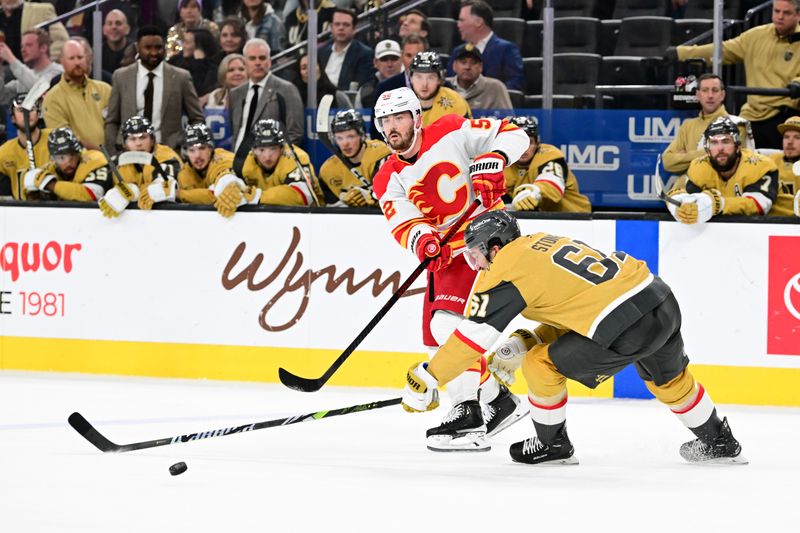 Oct 28, 2024; Las Vegas, Nevada, USA; Calgary Flames defenseman MacKenzie Weegar (52) makes a pass past Vegas Golden Knights right wing Mark Stone (61) in the second period at T-Mobile Arena. Mandatory Credit: Candice Ward-Imagn Images