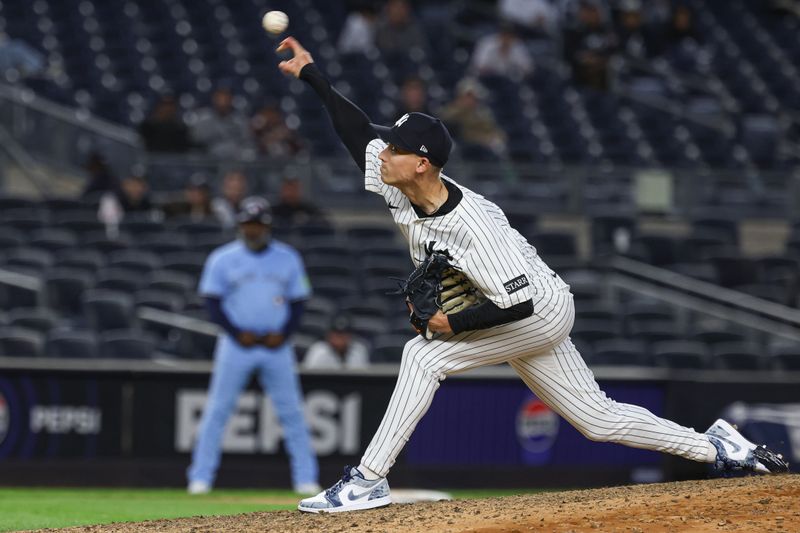 Apr 27, 2025; Bronx, New York, USA;  New York Yankees relief pitcher Luke Weaver (30) delivers a pitch during the ninth inning against the Toronto Blue Jays at Yankee Stadium. Mandatory Credit: Vincent Carchietta-Imagn Images