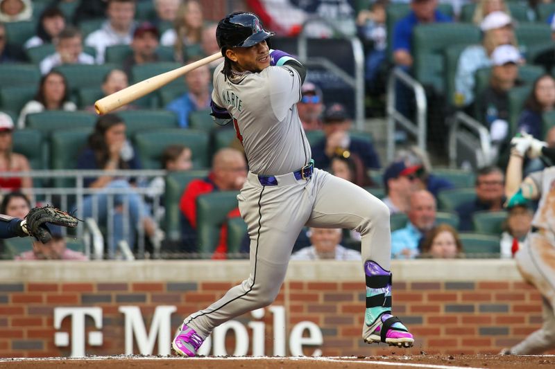 Apr 6, 2024; Atlanta, Georgia, USA; Arizona Diamondbacks second baseman Ketel Marte (4) hits a RBI double against the Atlanta Braves in the first inning at Truist Park. Mandatory Credit: Brett Davis-USA TODAY Sports