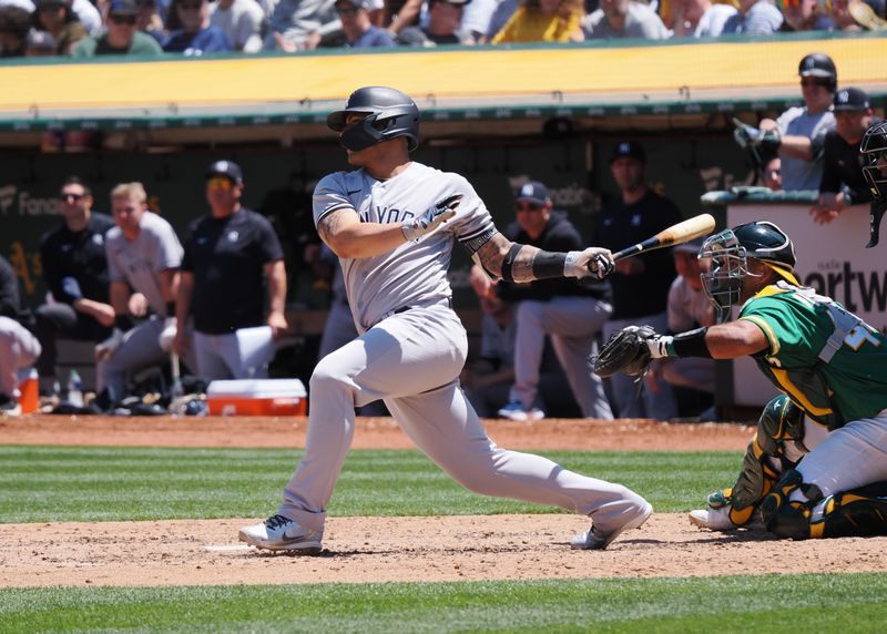 Jun 29, 2023; Oakland, California, USA; New York Yankees designated hitter Gleyber Torres (25) hits a two-run single against the Oakland Athletics during the sixth inning at Oakland-Alameda County Coliseum. Mandatory Credit: Kelley L Cox-USA TODAY Sports