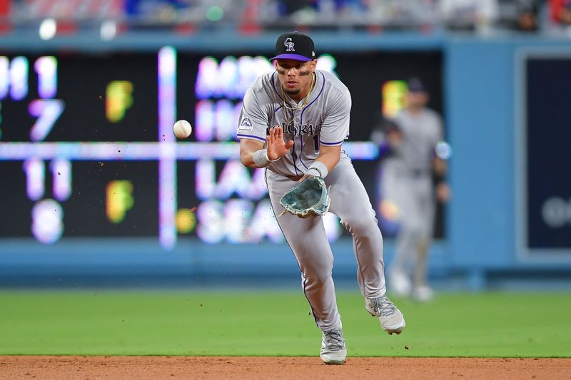 May 31, 2024; Los Angeles, California, USA; Colorado Rockies shortstop Ezequiel Tovar (14) fields the ground ball of Los Angeles Dodgers catcher Will Smith (16) during the ninth inning at Dodger Stadium. Mandatory Credit: Gary A. Vasquez-USA TODAY Sports