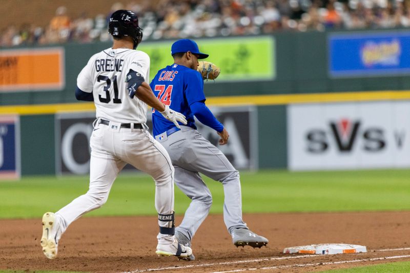 Aug 22, 2023; Detroit, Michigan, USA; Chicago Cubs relief pitcher Jose Cuas (74) makes a play at first base to get out Detroit Tigers center fielder Riley Greene (31) in the eighth inning at Comerica Park. Mandatory Credit: David Reginek-USA TODAY Sports