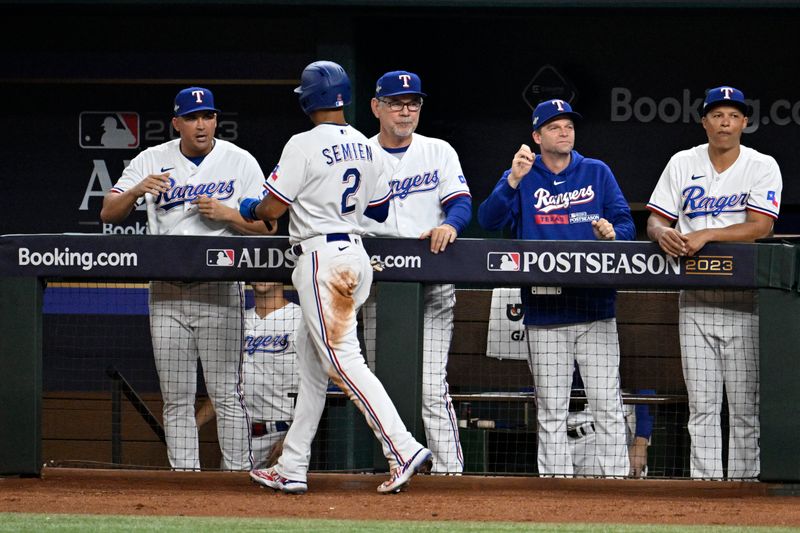 Oct 10, 2023; Arlington, Texas, USA; Texas Rangers second baseman Marcus Semien (2) celebrates with the dugout after scoring on a double by player Mitch Garver (not pictured) in the second inning against the Baltimore Orioles during game three of the ALDS for the 2023 MLB playoffs at Globe Life Field. Mandatory Credit: Jerome Miron-USA TODAY Sports