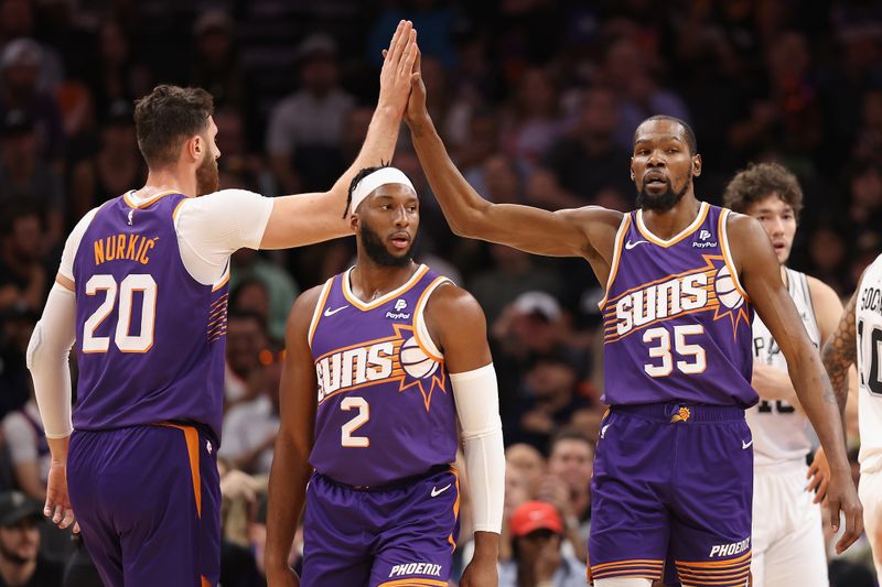 PHOENIX, ARIZONA - NOVEMBER 02: Kevin Durant #35 of the Phoenix Suns high fives Jusuf Nurkic #20 after scoring against the San Antonio Spurs during the first half of the NBA game at Footprint Center on November 02, 2023 in Phoenix, Arizona. NOTE TO USER: User expressly acknowledges and agrees that, by downloading and or using this photograph, User is consenting to the terms and conditions of the Getty Images License Agreement.  (Photo by Christian Petersen/Getty Images)