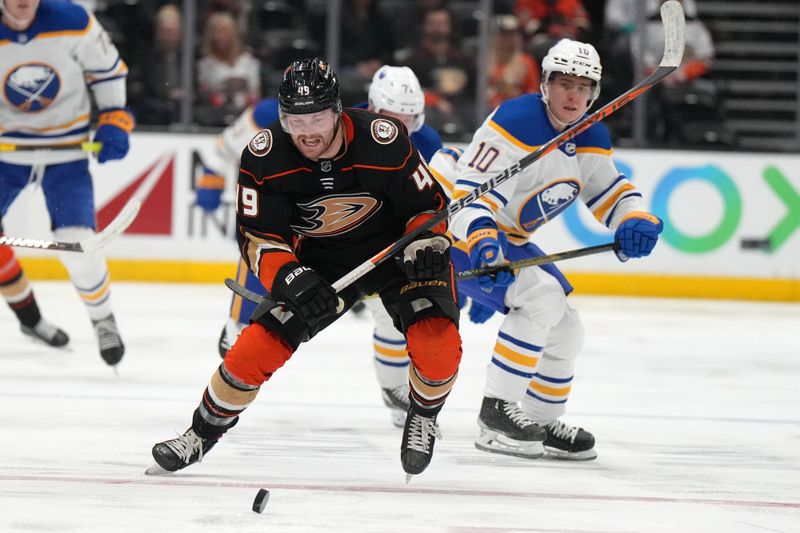 Feb 15, 2023; Anaheim, California, USA; Anaheim Ducks left wing Max Jones (49) and Buffalo Sabres center Peyton Krebs (19) battle for the puck in the second period  at Honda Center. Mandatory Credit: Kirby Lee-USA TODAY Sports