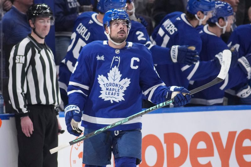 Mar 12, 2026; Toronto, Ontario, CAN; Toronto Maple Leafs forward Auston Matthews (34) looks up at the scoreboard after scoring against the Anaheim Ducks during the second period at Scotiabank Arena. Mandatory Credit: John E. Sokolowski-Imagn Images