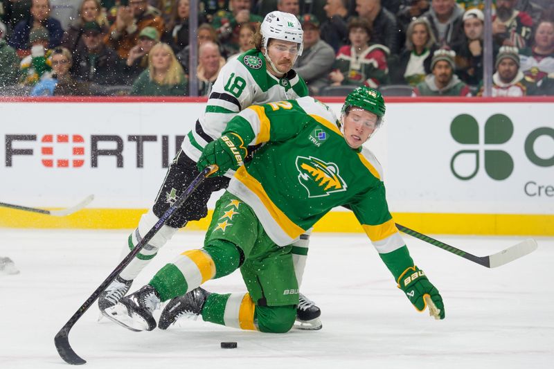 Dec 11, 2025; Saint Paul, Minnesota, USA; Minnesota Wild left wing Matt Boldy (12) is checked by Dallas Stars center Sam Steel (18) in the second period at Grand Casino Arena. Mandatory Credit: Matt Blewett-Imagn Images