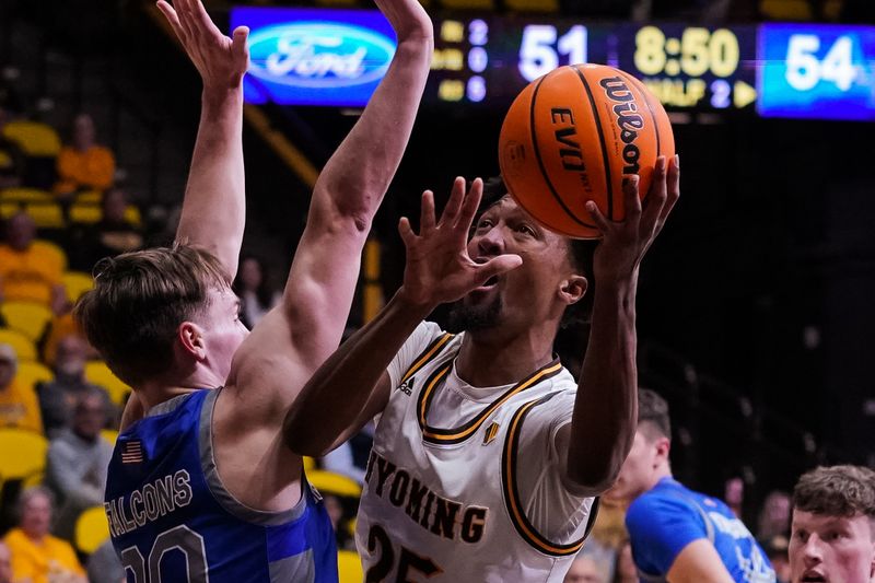 Feb 17, 2023; Laramie, Wyoming, USA; Wyoming Cowboys forward Jeremiah Oden (25) shoots against Air Force Falcons guard Camden Vander Zwaag (30) during the second half at Arena-Auditorium. Mandatory Credit: Troy Babbitt-USA TODAY Sports