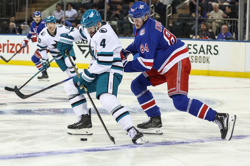 Oct 23, 2025; New York, New York, USA;  San Jose Sharks defenseman Nick Leddy (4) and New York Rangers center Adam Edstrom (84) battle for control of the puck in the first period at Madison Square Garden. Mandatory Credit: Wendell Cruz-Imagn Images