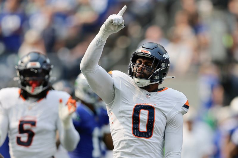 Denver Broncos linebacker Jonathon Cooper (0) celebrates after a sack during the first half of an NFL football game against the Seattle Seahawks, Sunday, Sept. 8, 2024, in Seattle. (AP Photo/John Froschauer)