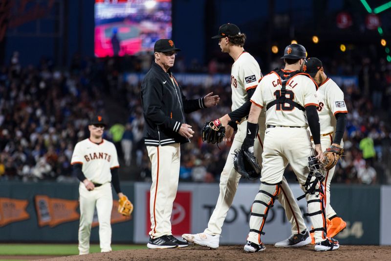 May 15, 2024; San Francisco, California, USA; San Francisco Giants manager Bob Melvin (6) lifts pitcher Sean Hjelle (64) before the pitch against Los Angeles Dodgers designated hitter Shohei Ohtani (17) during the seventh inning at Oracle Park. Mandatory Credit: John Hefti-USA TODAY Sports