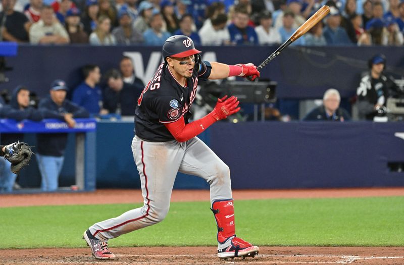 Aug 28, 2023; Toronto, Ontario, CAN;  Washington Nationals designated hitter Joey Meneses (45) hits a two-RBI double against the Toronto Blue Jays in the fifth inning at Rogers Centre. Mandatory Credit: Dan Hamilton-USA TODAY Sports