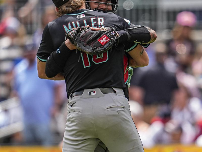 Jun 5, 2025; Cumberland, Georgia, USA; Arizona Diamondbacks relief pitcher Shelby Miller (18) reacts with catcher Jose Herrera (11) after the Diamondbacks defeated the Atlanta Braves at Truist Park. Mandatory Credit: Dale Zanine-Imagn Images