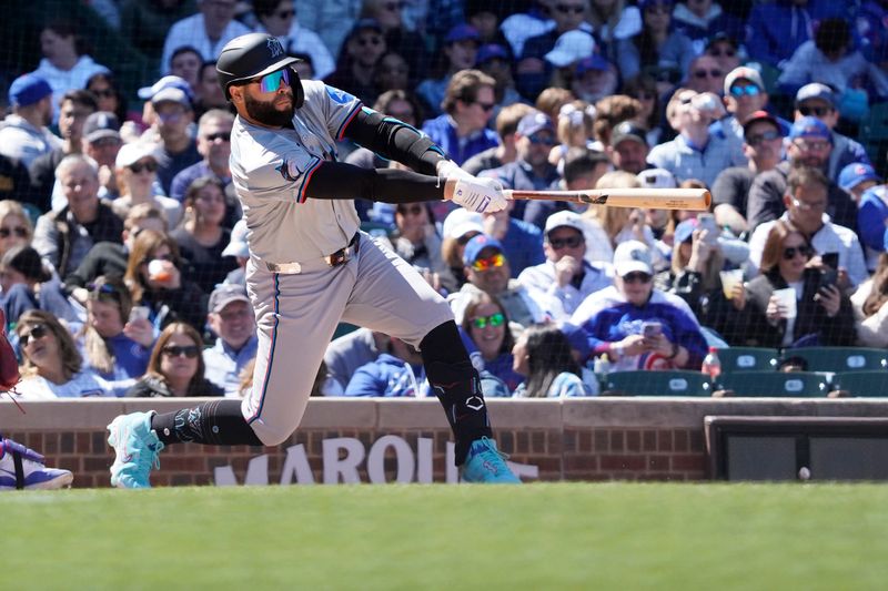 Apr 19, 2024; Chicago, Illinois, USA; Miami Marlins third baseman Emmanuel Rivera (15) hits a single Chicago Cubs during the fifth inning at Wrigley Field. Mandatory Credit: David Banks-USA TODAY Sports