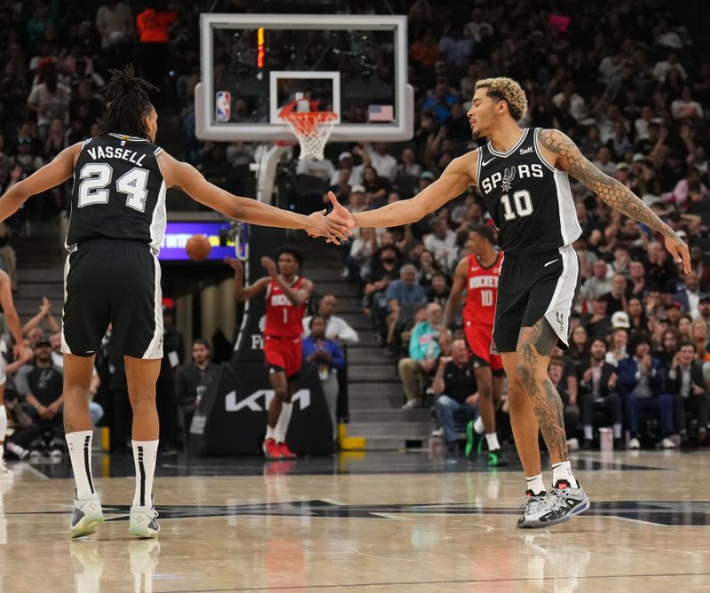 SAN ANTONIO, TX - MARCH 12: Devin Vassell #24 and Jeremy Sochan #10 of the San Antonio Spurs high five during the game against the Houston Rockets on March 12, 2024 at the Frost Bank Center in San Antonio, Texas. NOTE TO USER: User expressly acknowledges and agrees that, by downloading and or using this photograph, user is consenting to the terms and conditions of the Getty Images License Agreement. Mandatory Copyright Notice: Copyright 2024 NBAE (Photos by Jesse D. Garrabrant/NBAE via Getty Images)