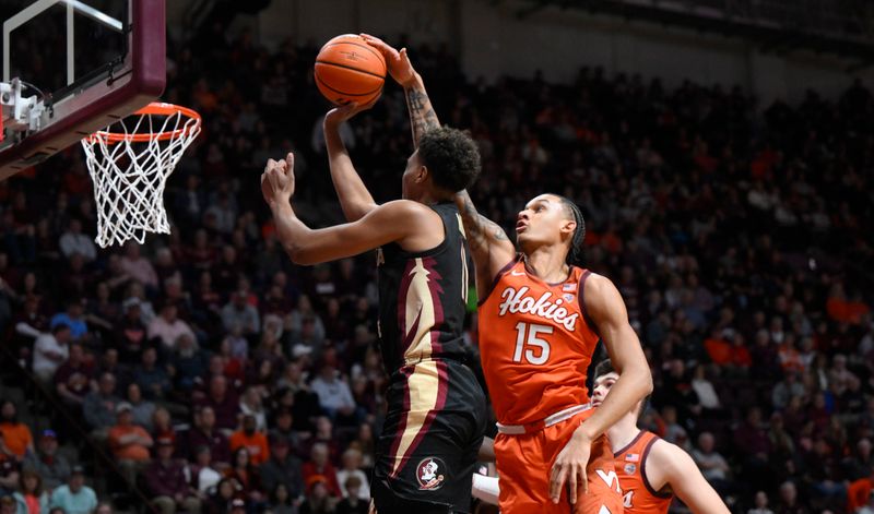 Mar 4, 2023; Blacksburg, Virginia, USA; Virginia Tech Hokies center Lynn Kidd (15) blocks a shot by Florida State Seminoles forward Baba Miller (11)  in the first half at Cassell Coliseum. Mandatory Credit: Lee Luther Jr.-USA TODAY Sports