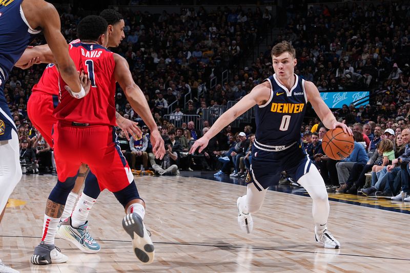 DENVER, CO - FEBRUARY 22: Christian Braun #0 of the Denver Nuggets dribbles the ball during the game against the Washington Wizards on February 22, 2024 at the Ball Arena in Denver, Colorado. NOTE TO USER: User expressly acknowledges and agrees that, by downloading and/or using this Photograph, user is consenting to the terms and conditions of the Getty Images License Agreement. Mandatory Copyright Notice: Copyright 2024 NBAE (Photo by Garrett Ellwood/NBAE via Getty Images)