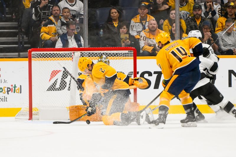 Nov 4, 2024; Nashville, Tennessee, USA;  Nashville Predators defenseman Luke Schenn (2) blocks the shot of Los Angeles Kings defenseman Caleb Jones (82) during the first period at Bridgestone Arena. Mandatory Credit: Steve Roberts-Imagn Images