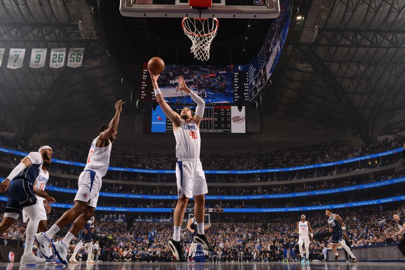 DALLAS, TX - APRIL 26: Ivica Zubac #40 of the LA Clippers rebounds the ball during the game against the Dallas Mavericks during Round 1 Game 3 of the 2024 NBA Playoffs on April 26, 2024 at the American Airlines Center in Dallas, Texas. NOTE TO USER: User expressly acknowledges and agrees that, by downloading and or using this photograph, User is consenting to the terms and conditions of the Getty Images License Agreement. Mandatory Copyright Notice: Copyright 2023 NBAE (Photo by Glenn James/NBAE via Getty Images)